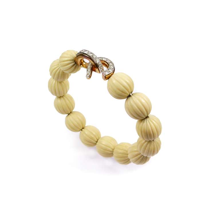 Mid-20th century diamond, gold and fluted white corallium bead bangle